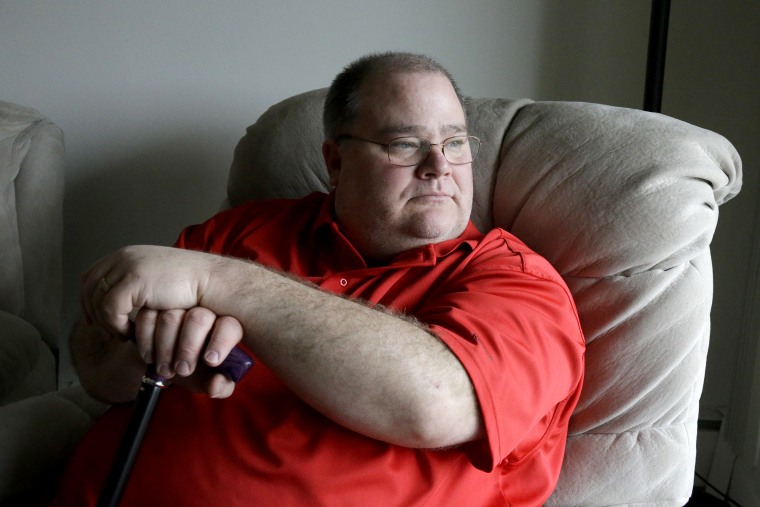 Patrick McClellan is seen in his home in Bloomington, Minn., on  March 27, 2014. McClellan uses a marijuana vaporizer to control muscle spasms caused by mitochondrial myopathy.