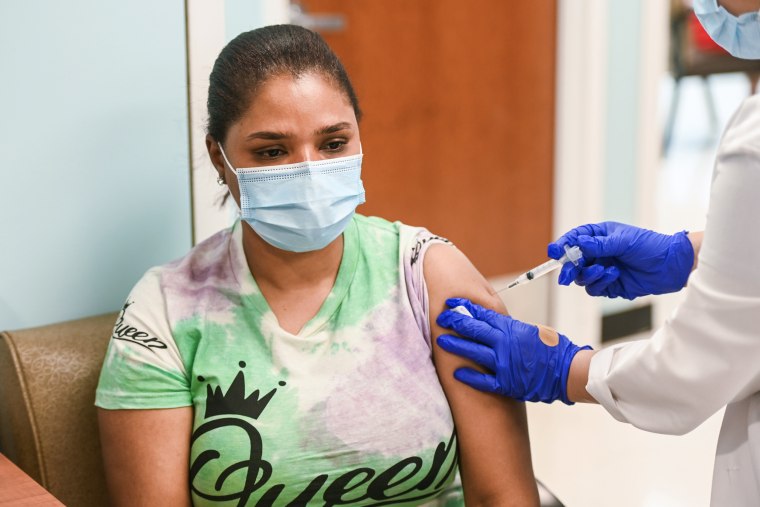 A woman receives a Covid-19 vaccine from a registered nurse at the Roosevelt Family Health Center of Long Island in Roosevelt, N.Y., on July 8, 2021.