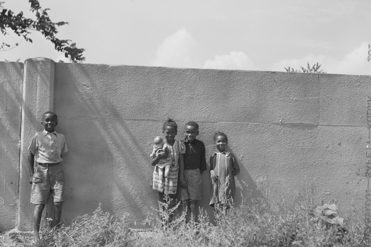 Children stand in front of the Birwood Wall in August 1941.