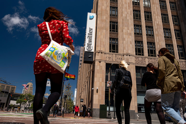 Image: People cross the street in front of the Twitter Inc. headquarters in San Francisco on June 9, 2021.