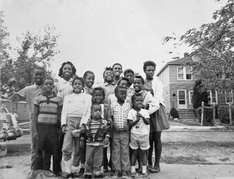 Teresa Moon, fourth from left in back row, and her cousins on her still-unpaved street in the early 1960s.
