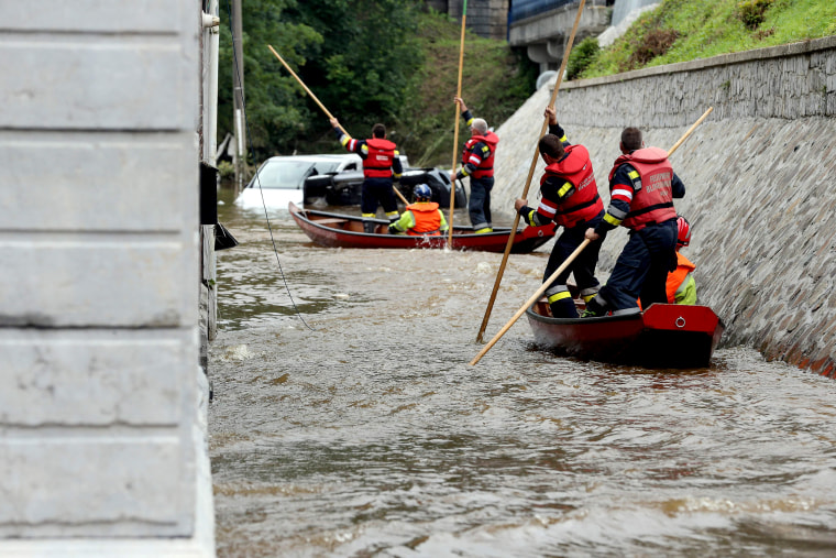 Image: Austrian firefighters steer a boat in a flooded street in Pepinster, Belgium on July 16, 2021, where the situation remains critical after the heavy rainfall of the previous days.