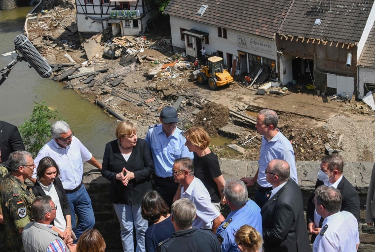 German Chancellor Angela Merkel, third from left, visits the flood-ravaged areas to survey the damage and meet survivors in Schuld on July 18, 2021.