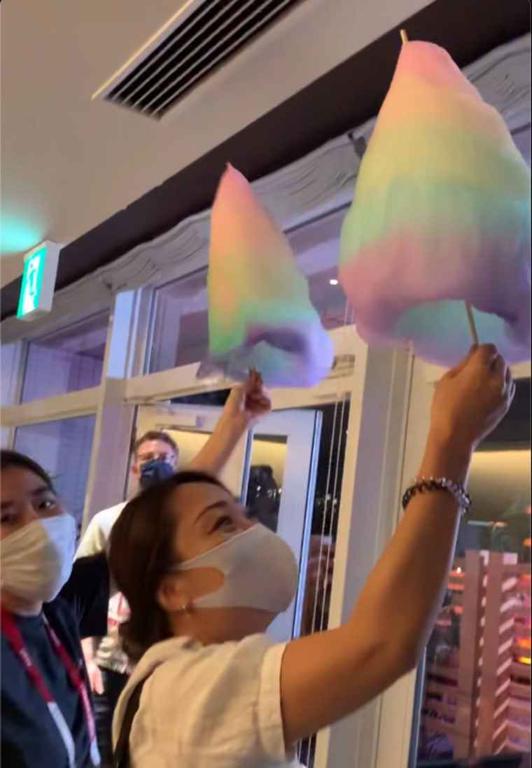 TODAY staffers hold the rainbow cotton candy close to the AC to prevent it from melting.