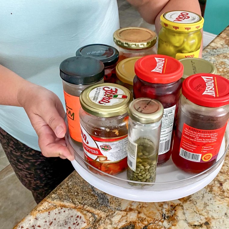 Image of Terri Peters holding a lazy susan with condiments in it
