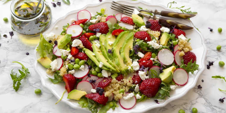 salad with quinoa, rucola, avocado, radish, strawberries, fetacheese, peas