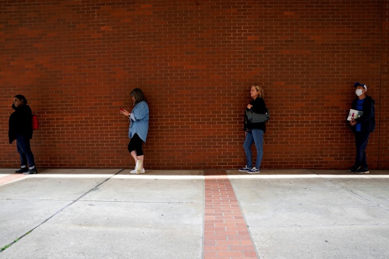 Image: People who lost their jobs wait in line to file for unemployment benefits, following an outbreak of the coronavirus disease (COVID-19), at Arkansas Workforce Center in Fort Smith