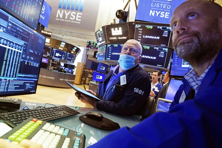 Trader Thomas Ferrigno, left, and specialist Meric Greenbaum work on the floor of the New York Stock Exchange on July 16, 2021.