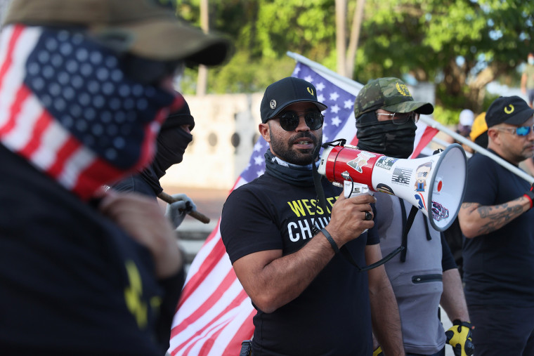 Image: Enrique Tarrio, leader of the Proud Boys, uses a megaphone while counter-protesting people gathered at the Torch of Friendship to commemorate the one year anniversary of the killing of George Floyd on May 25, 2021 in Miami.
