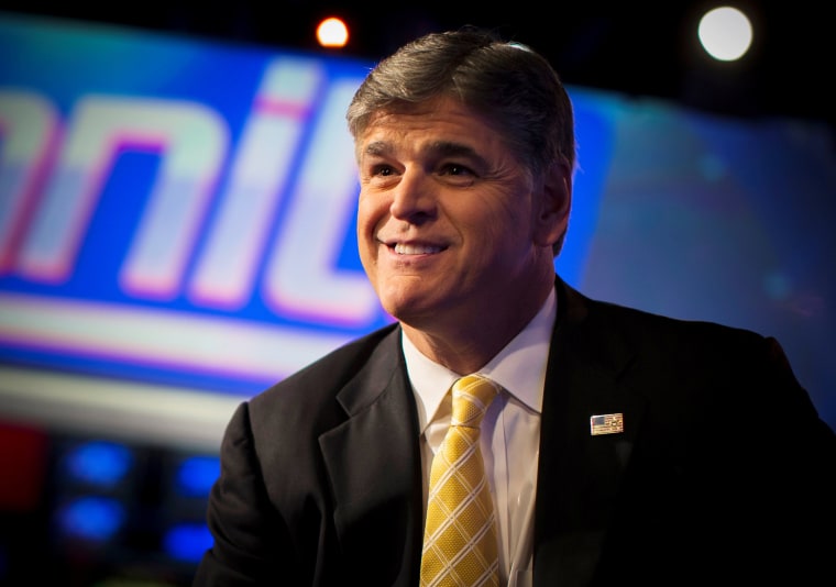 Image: FILE PHOTO - Fox News Channel anchor Sean Hannity poses for photographs as he sits on the set of his show \"Hannity\" at the Fox News Channel's headquarters in New York City