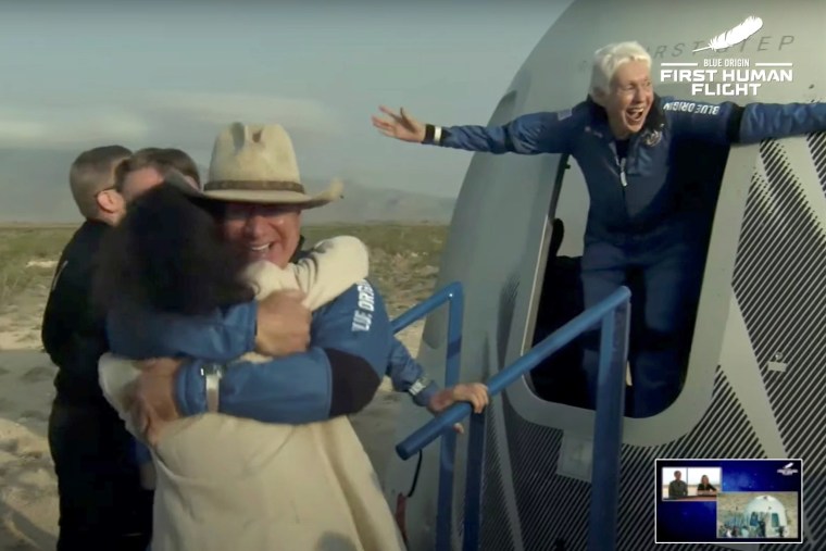 Image: Billionaire businessman Jeff Bezos and pioneering female aviator Wally Funk emerge from their capsule