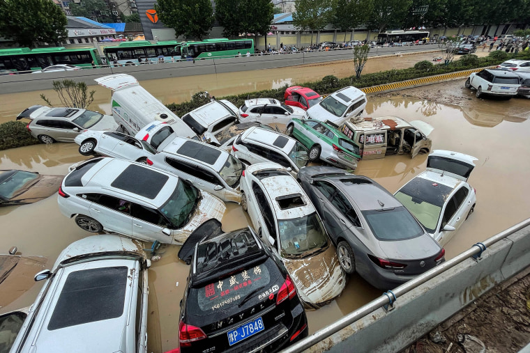 Image: Cars sit in floodwaters after heavy rains hit the city of Zhengzhou in China's central Henan province