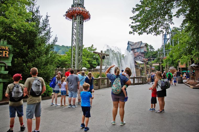 Image: Visitors watch others ride the "Dropline" at Dollywood on July 20.