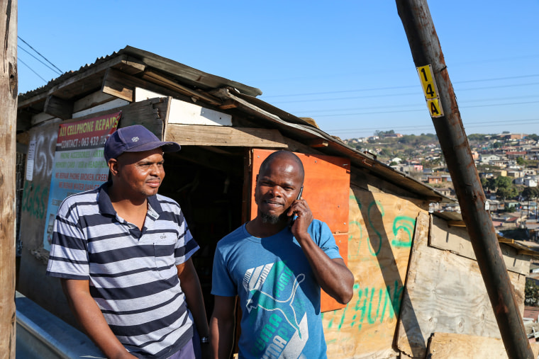 Image: Richard Ncube, left, and Dawood Phillip had devices and parts stolen from their cellphone repair shop during widespread unrest in Durban, South Africa last week.