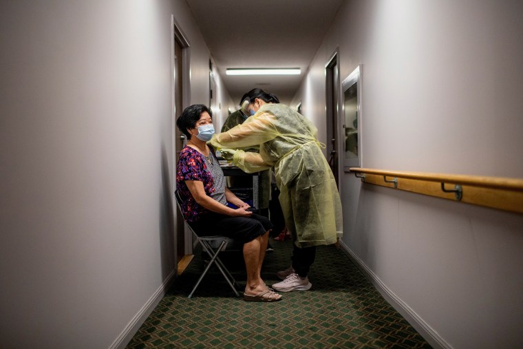 Catherine Serrano administers the Pfizer/BioNTech vaccine to a resident at Caboto Terrace, an independent seniors residence in Toronto, Canada.