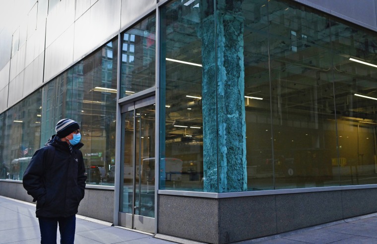 A man walks past an empty office building in the midtown area of Manhattan on Jan. 25, 2021.