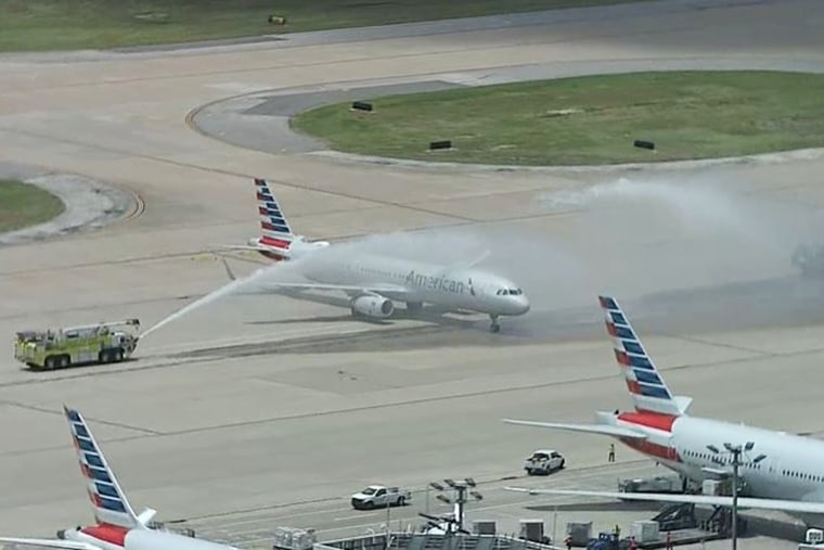 A plane carrying Elijah Snow's remains is saluted by firetrucks at Dallas-Fort Worth International Airport.