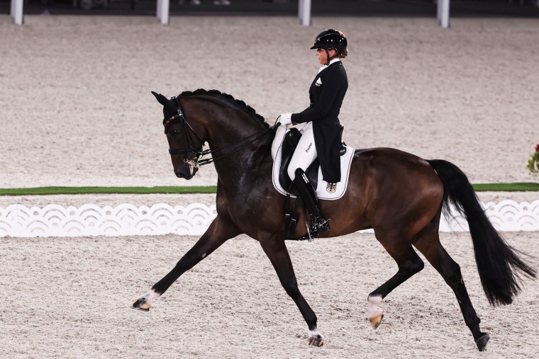 aGermany's Dorothee Schneider competes in dressage with her horse Showtime FRH at the Olympics on July 25, 2021, in Tokyo.