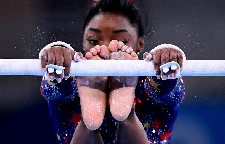 Simone Biles competes on the uneven bars at the Tokyo Games on July 25, 2021.
