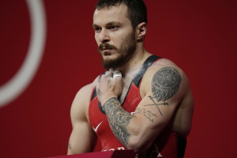 Shota Mishvelidze of Georgia prepares to compete in the men's 61kg weightlifting event, at the 2020 Summer Olympics, Sunday, July 25, 2021, in Tokyo, Japan.