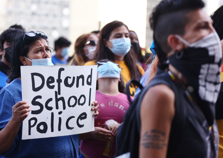 Image: People protest outside the Unified School District headquarters calling on the board of education to 'fully defund' Los  Angeles school police on June 22, 2021.