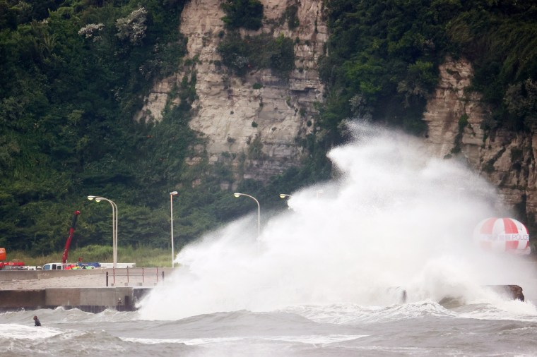 Image: Waves crashing against a seawall as stormy weather conditions at Tsurigasaki Surfing Beach, Tokyo on Monday.