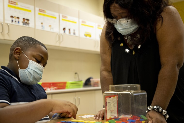 Donylen Bullock works on multiplication with his teacher, Nechia Coleman, during summer school at Ida Green Elementary in Belzoni, Miss., on June 30, 2021.