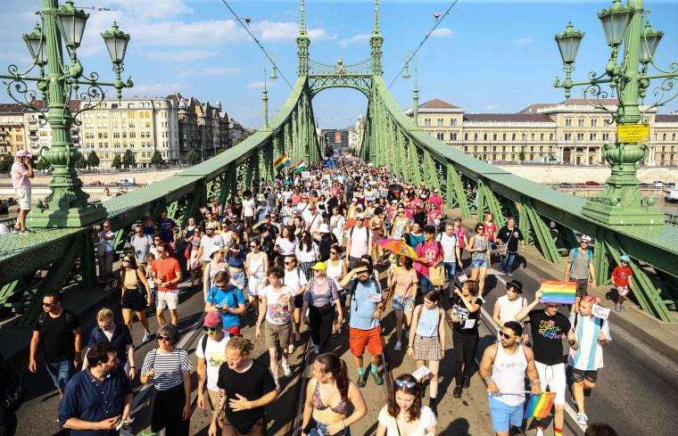 People cross the Liberty Bridge during the Budapest Pride Parade on July 24, 2021.