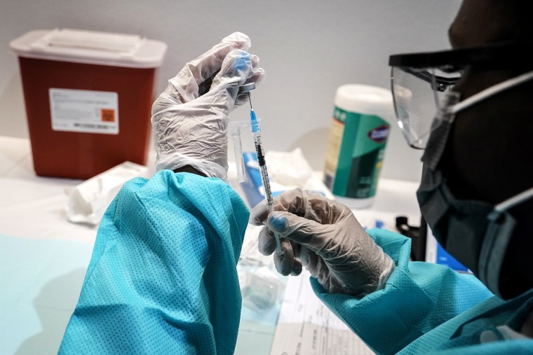 Image: A health care worker fills a syringe with the Pfizer COVID-19 vaccine at the American Museum of Natural History in New York on July 22, 2021.
