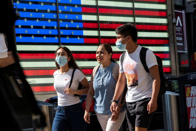 Image: People wear masks around Times Square, as cases of the infectious coronavirus Delta variant continue to rise in New York City, New York