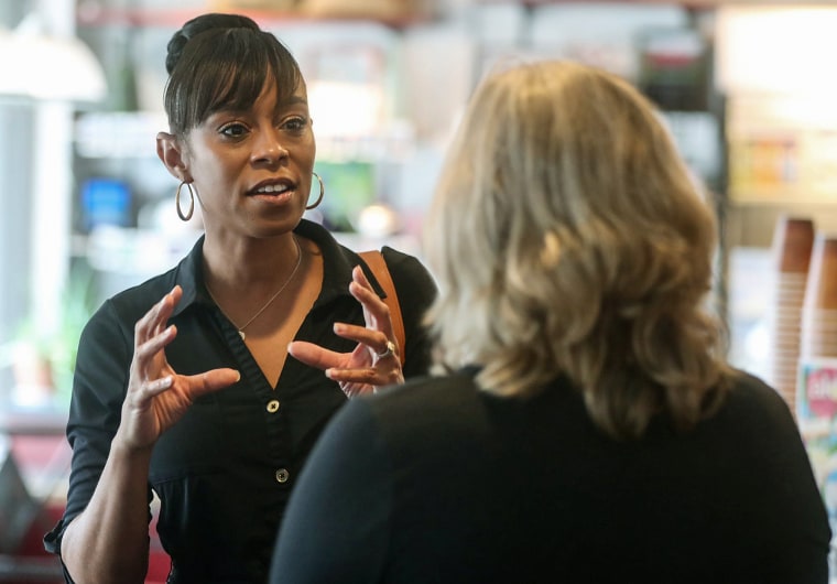 Shontel Brown, a candidate vying to represent Ohio's 11th Congressional District, talks with Nancy Holland, Akron city council ward 1, at Angel Falls Coffee shop during a campaign stop in Akron on July 14, 2021.