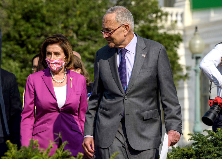 Image: House Speaker Nancy Pelosi and Senate Majority Leader Chuck Schumer arrive at a press conference on climate change at the U.S. Capitol on July 28, 2021.
