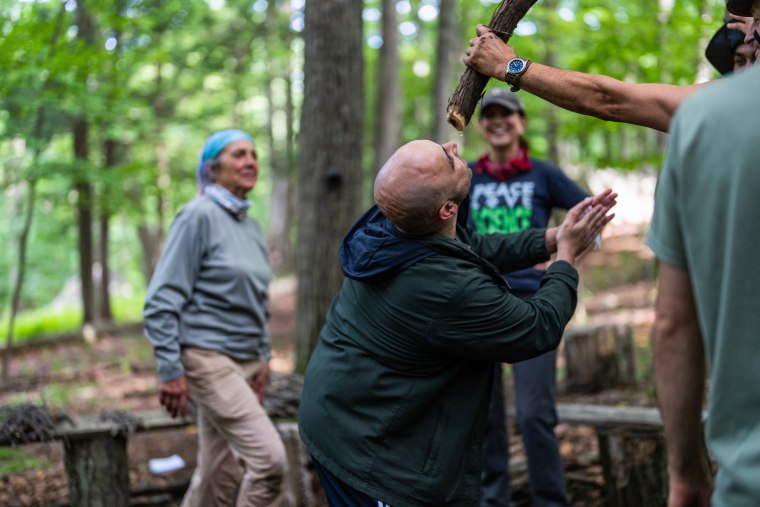 Shane Hobel demonstrates a technique for finding water in the forests of the northeastern United States.