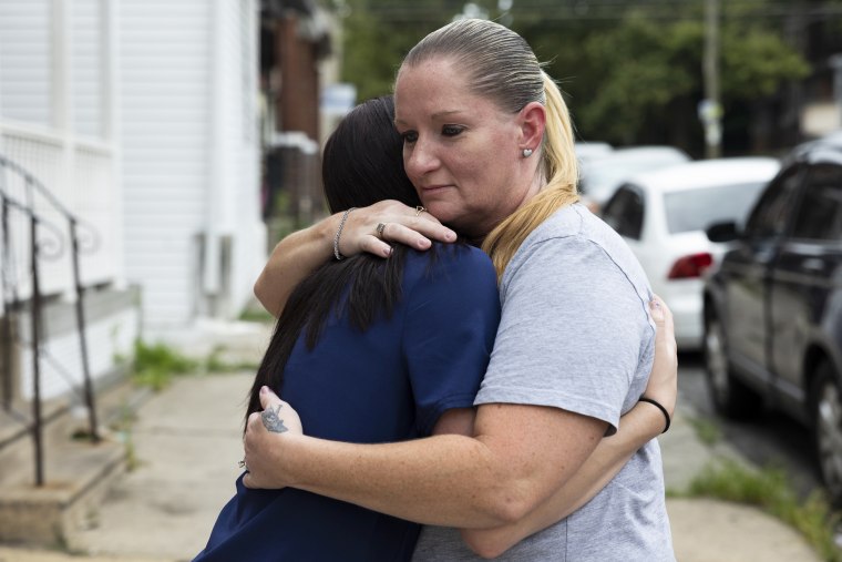 Miltreda Kress hugs her daughter, Brianna Donahue, in front of their home in Philadelphia.