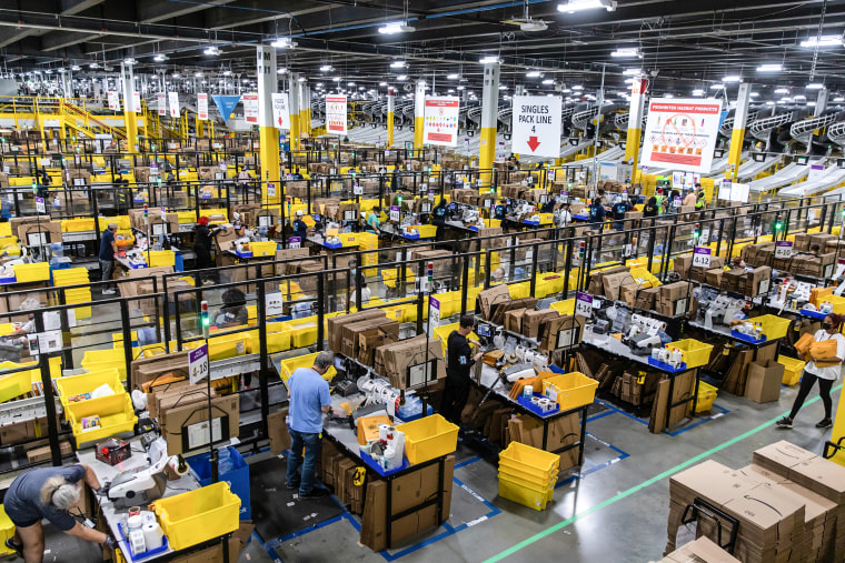 Workers fulfill orders at an Amazon fulfillment center on Prime Day in Raleigh, N.C., on June 21, 2021.