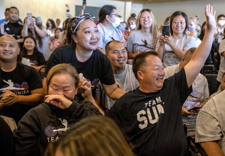 Image: Sunisa Lee's parents Yeev Thoj, left, and John Lee and other family and friends react as they watch Sunisa Lee clinch the gold medal in the women's Olympic gymnastics all-around at the Tokyo Olympics on July 29, 2021 in Oakdale, Minn.