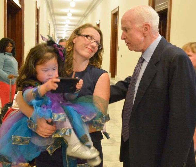 Austin Carrigg spends much of her time advocating for better health care for her daughter and others like her. Here, she speaks with former Sen. John McCain in Washington, D.C.