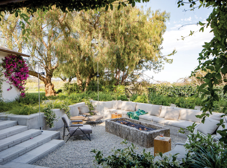 The backyard features a sunken conversation pit that seems perfect for gathering with friends and family.