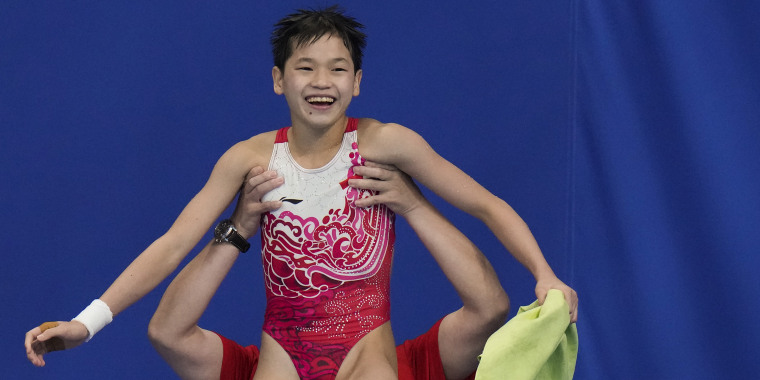 Quan Hongchan of China celebrates after competing in women's diving 10-meter platform final at the 2020 Summer Olympics, Thursday, Aug. 5, 2021, in Tokyo, Japan. (AP Photo/Alessandra Tarantino)