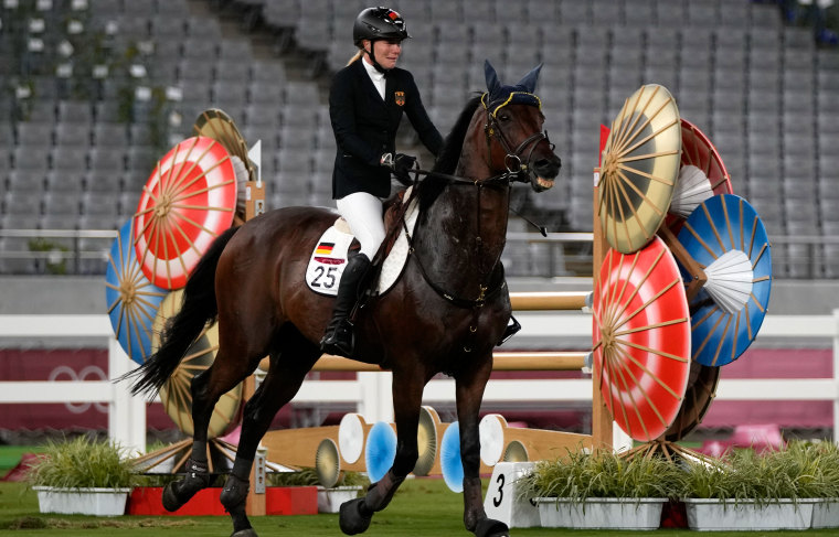 Annika Schleu of Germany cries as she couldn't control her horse.