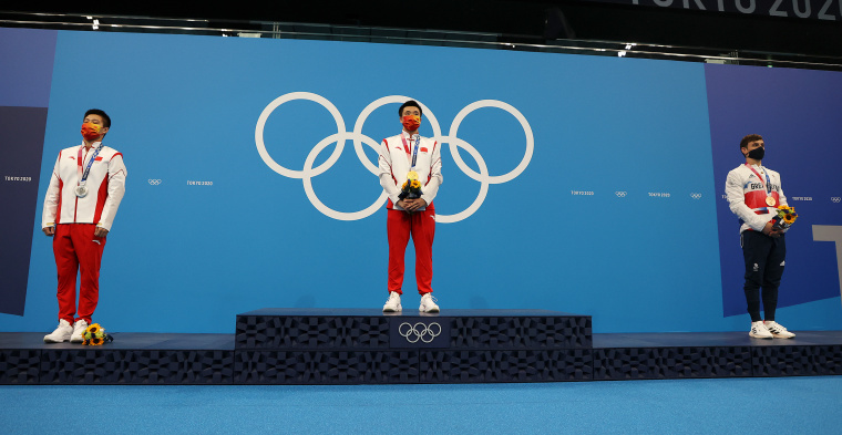 ilver medalist Jian Yang of Team China, gold medalist Yuan Cao of Team China and bronze medalist Thomas Daley of Team Great Britain during the medal ceremony.