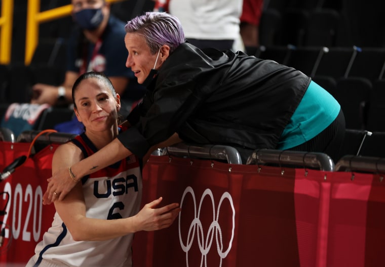 Megan Rapinoe congratulates Sue Bird #6 of Team United States after the United States' win over Japan in the Women's Basketball final game on day sixteen of the 2020 Tokyo Olympic games at Saitama Super Arena on August 08, 2021.