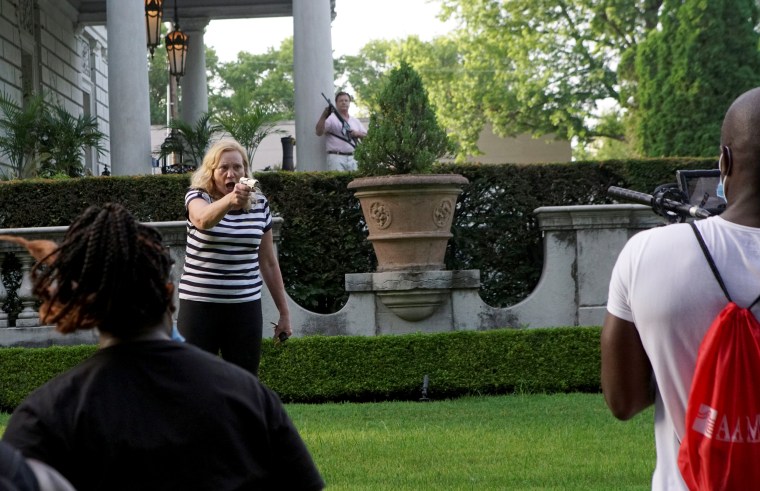 Image: A couple draws guns at protesters in St. Louis on June 28, 2020.