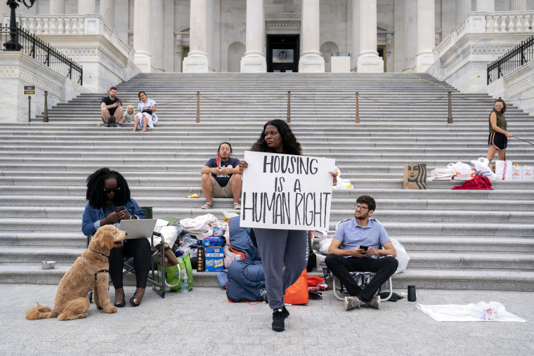 Rep. Cori Bush, D-Mo., center, joined by Congressional staffers and activists, protests the expiration of the eviction moratorium outside the Capitol on July 31, 2021.