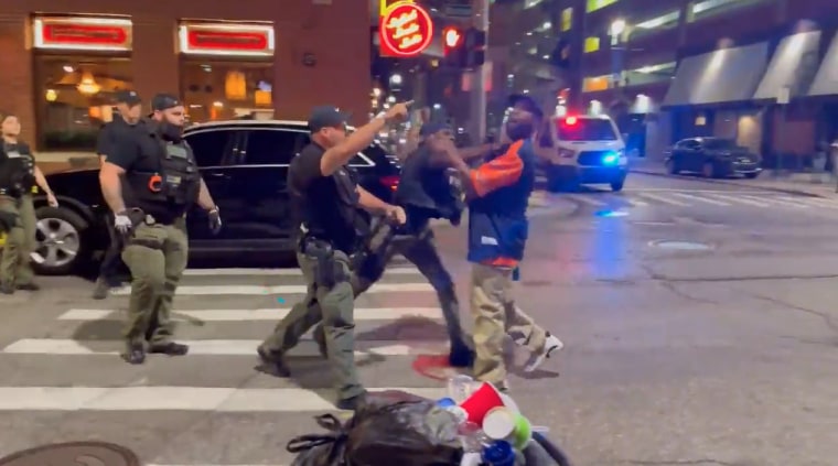 A video recorded Sunday shows officers approach a man in a Detroit Tigers' shirt, who appeared to be speaking to them when an officer struck him in the face, knocking him to the ground.