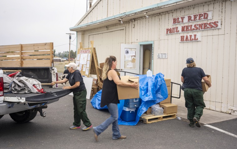 Volunteers unload donated lunches at the Bly Fire Department in Bly, Ore., on July 31, 2021.