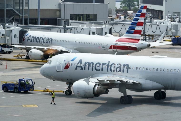 American Airlines passenger jets prepare for departure on July 21, 2021, near a terminal at Boston Logan International Airport.