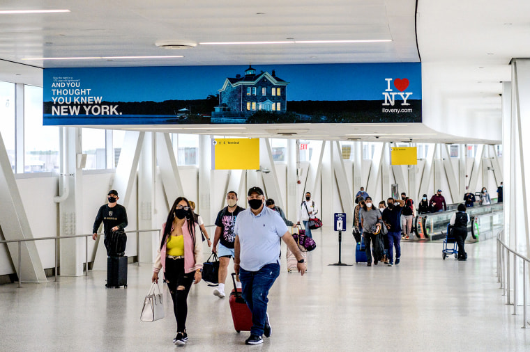 Travelers walk through John F. Kennedy Airport on May 28, 2021 in New York.