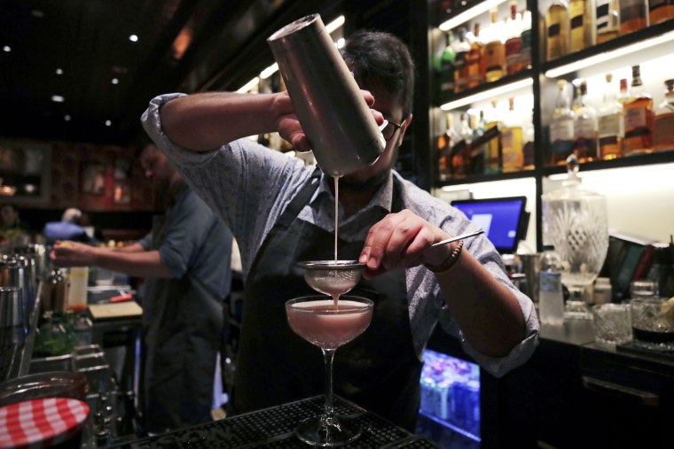 A mixologist crafts a cocktail at a bar, in Boston in 2019.