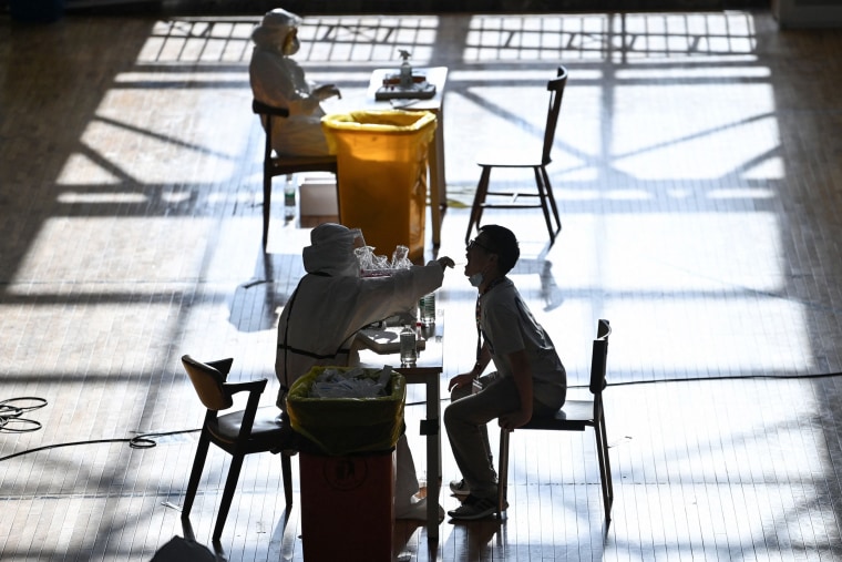 Image: A person is given a test for the coronavirus in Wuhan, China 